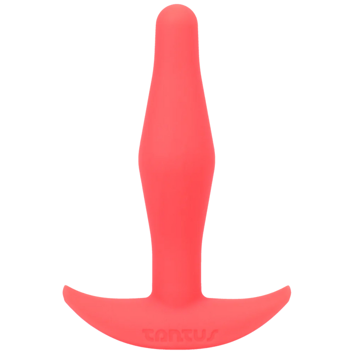 Tantus Little Flirt small tapered silicone butt plug in coral with a wide base for secure fit and comfort.