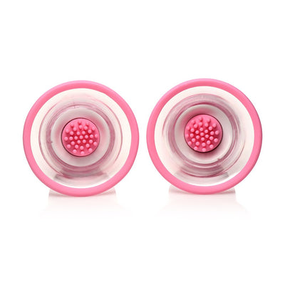 Pair of pink rotating silicone nipple suckers with textured nub attachments inside clear suction cups.