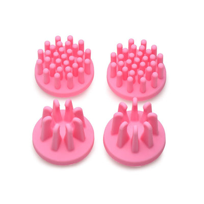 Set of four pink silicone rotating nipple sucker attachments with varied nub shapes for targeted stimulation.