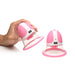 Pair of pink and white rotating silicone nipple suckers with textured attachments, one held in hand and one standing upright.