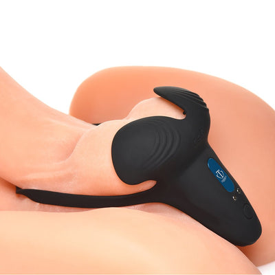 Black silicone vibrating cock ring with taint stimulator and remote control shown on a realistic skin-toned model.