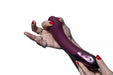 Hand holding a plum-colored Hot Octopuss Kurve G-spot vibrator with ergonomic shape and control buttons visible.