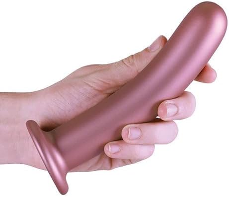 Hand holding a smooth rose gold silicone G-spot dildo with a strong suction base.