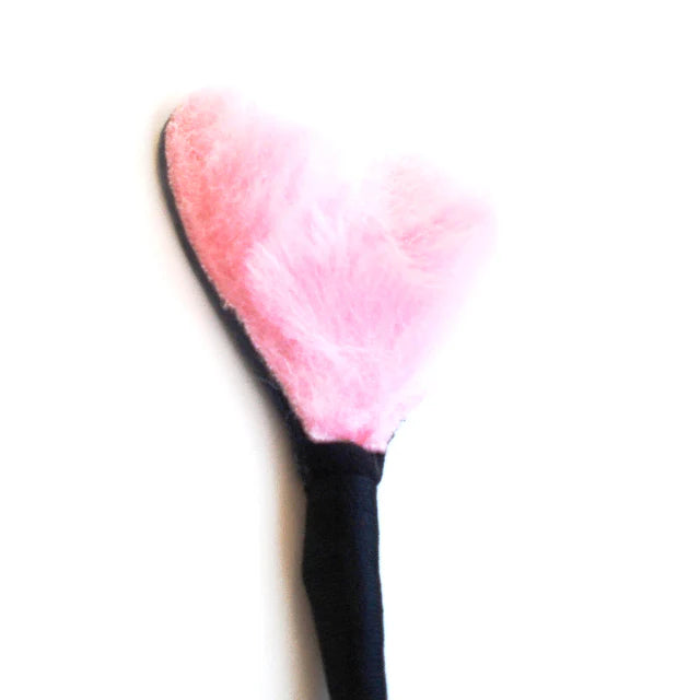 Pink heart-shaped fluffy tip attached to a black handle crop for gentle caresses and playful teasing.
