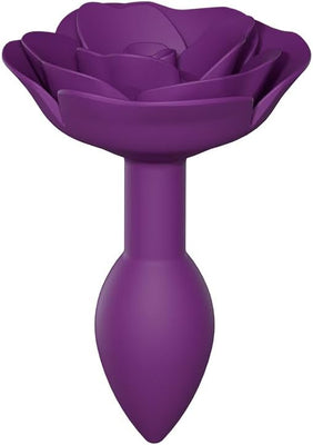 Small purple silicone anal plug designed as an open rose with soft petal texture and ergonomic shape.
