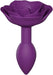 Small purple silicone anal plug designed as an open rose with soft petal texture and ergonomic shape.