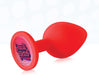 Red silicone butt plug with a flared base featuring a colorful "Fuck Yeah" graphic design.