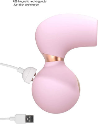 Pink ergonomic clitoral vibrator with USB magnetic rechargeable charging cable attached.