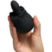 Hand holding a black silicone rose-shaped rimming toy with vibration and rotation features.