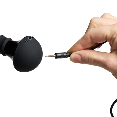 Hand holding a plug near the charging port of a black Vive Enoki bendable massager against a white background.