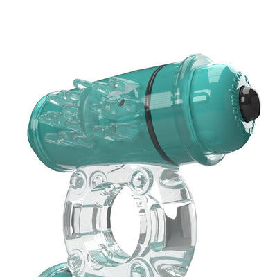 Transparent and teal vibrating ring with textured stimulator and push-button control on a white background.