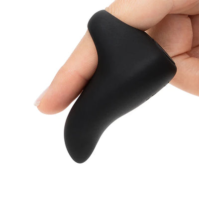 Hand holding a sleek black silicone finger vibrator with a curved rounded tip designed for precise stimulation.