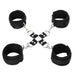 Black adjustable hog tie set with four soft cuffs connected by metal rings and clips on a white background.