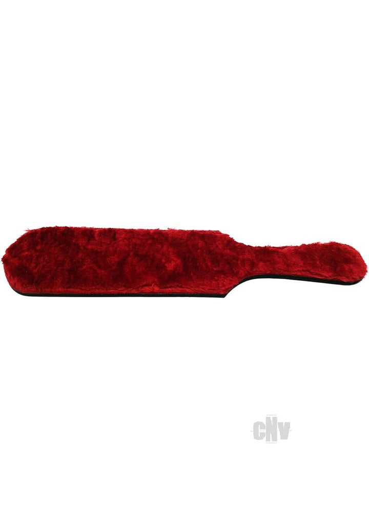 Red dual-sided paddle with soft fur surface and leather backing, featuring a comfortable handle grip.
