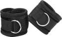 Pair of black velvet and velcro adjustable handcuffs with metal D-rings for secure restraint.