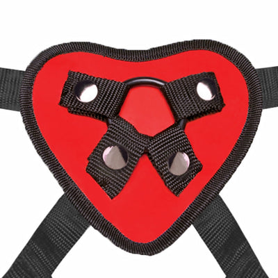 Red heart-shaped strap on harness with black adjustable straps and metal snap fasteners.