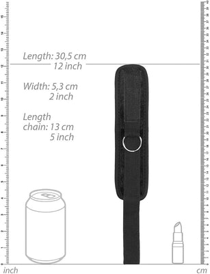 Black velvet and velcro adjustable handcuff with metal ring, shown with size measurements on white background.