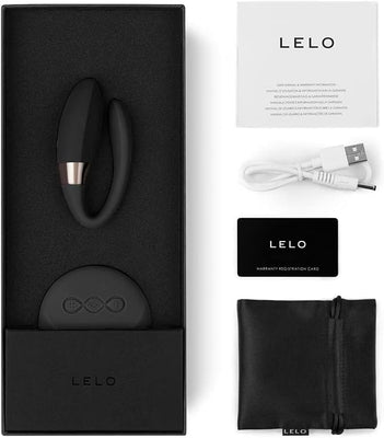 LELO Tiani 2 couples massager with remote, USB charging cable, warranty card, user manual, and black storage pouch in packaging.
