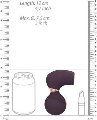 Compact dark purple clitoral vibrator with rose gold accent, shown next to size comparison of soda can and lipstick.