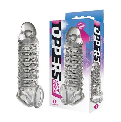 Clear ribbed and nubbed open-ended penis extender displayed next to its colorful packaging box.
