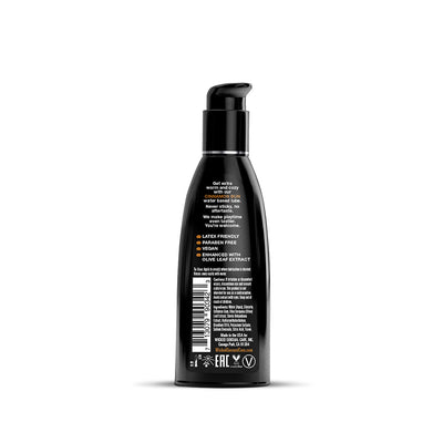 Back view of Wicked Aqua Cinnamon Bun water-based lubricant bottle with usage instructions and product details on black packaging.