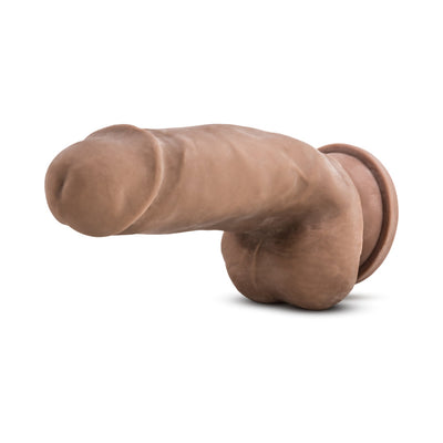 Realistic 7-inch brown TPE dildo with suction cup base and lifelike texture, flexible for versatile use.