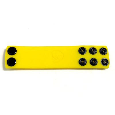 Yellow silicone ball strap stretcher with multiple black snap fasteners for adjustable sizing.