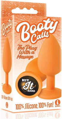 Orange silicone butt plug with "Hit It Hard" message on the base, packaged in a matching orange box labeled Booty Calls.