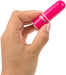 Hand holding a compact, bright pink bullet vibrator with a smooth, rounded design.
