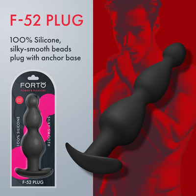 Black FORTO F-52 silicone plug with smooth, curved beads and flared base shown with packaging and red-toned background.