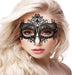 Close-up of a woman wearing an intricate black lace Venetian-inspired mask with delicate floral patterns.