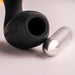 Close-up of the black Naughty Boy prostate stimulator with its removable silver vibrating bullet on a light surface.