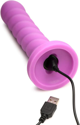 Magenta silicone vibrator with soft swirl texture and USB charging cable connected at base.