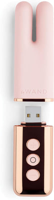 Le Wand Deux mini vibrator in soft pink with rose gold USB charger and control buttons visible