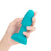Hand holding a compact turquoise silicone B-Vibe Rimming Petite Plug designed for beginner anal play.