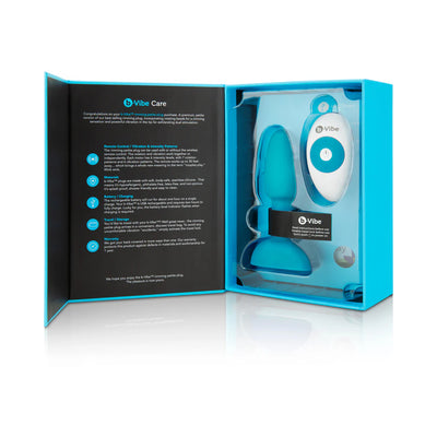 B-Vibe Rimming Petite Plug in blue with wireless remote control displayed in open blue packaging box with care instructions.