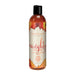 Bottle of Intimate Earth Naughty Nectarines natural flavored pleasure glide with peach-themed label and black cap.