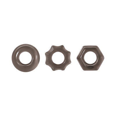 Set of three smoke-colored thick cock rings in circle, star, and hexagon shapes with smooth and textured designs.