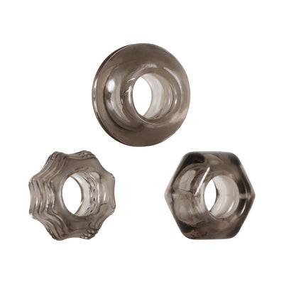 Set of three smoke-colored thick cock rings in circle, star, and hexagon shapes with textured designs.