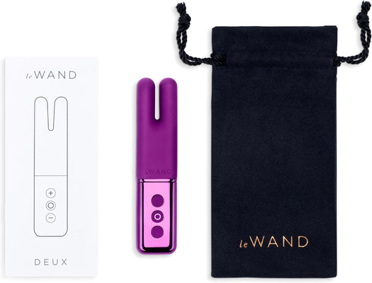 Le Wand Deux purple dual-ended mini vibrator with control buttons, white box, and black drawstring storage pouch.