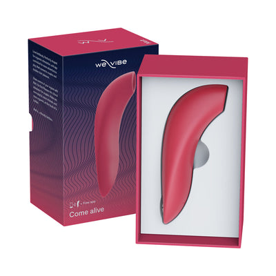 We-Vibe Melt clitoral suction stimulator in pink silicone displayed in open box with packaging.