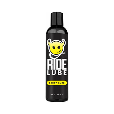 Black bottle of Ride Lube Booty Buzz silicone-based personal lubricant with yellow devil smiley logo and bold white text.