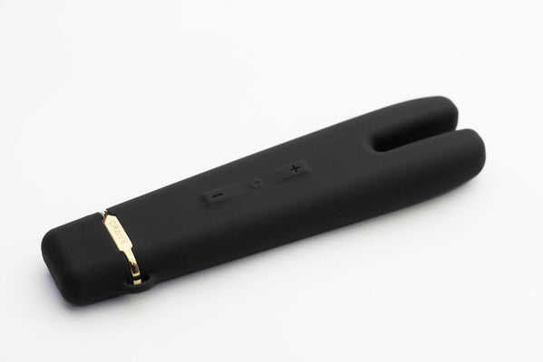 Black dual-tip vibrator with gold accent and control buttons, sleek silicone design on white background.