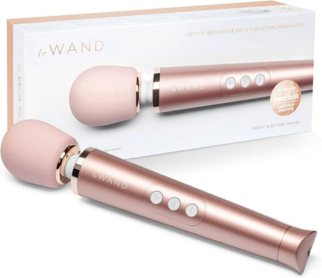 Le Wand Petite rechargeable massager in rose gold with soft rounded head and control buttons displayed with packaging box.