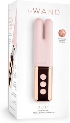 Le Wand Deux twin motor rechargeable mini vibrator in pink with rose gold accents on white packaging box.