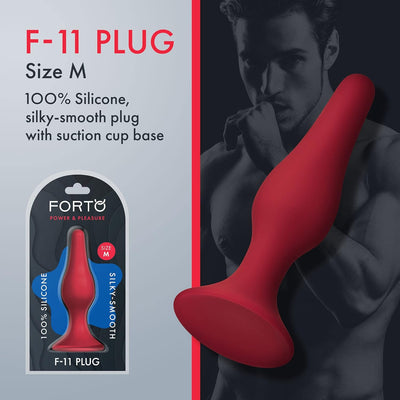 Red FORTO F-11 Lungo silicone plug with suction cup base shown in packaging and held by a shirtless man.