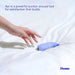 Hand reaching for a compact lavender Dame Aer Air Pulse Stimulator on a white bedspread with product description text.