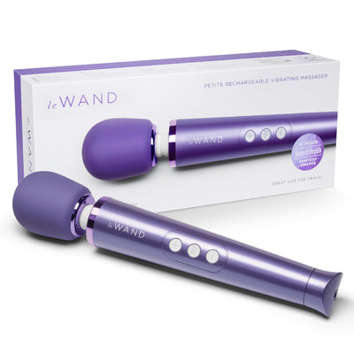 Purple Le Wand Petite rechargeable vibrating massager with control buttons and packaging box in the background.
