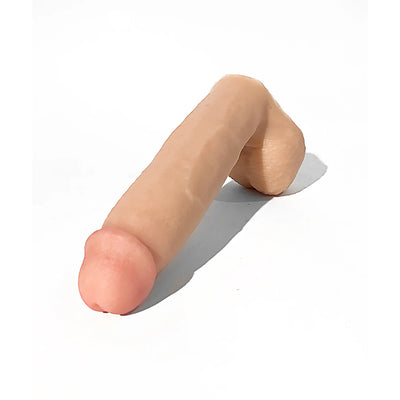Realistic flesh-tone silicone dildo with detailed head and textured base on white background