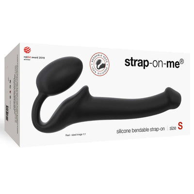 Black silicone bendable strapless strap-on with ergonomic design shown on white packaging box.
